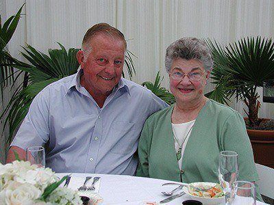 Fred and Mary Gellner smile at a dinner table.